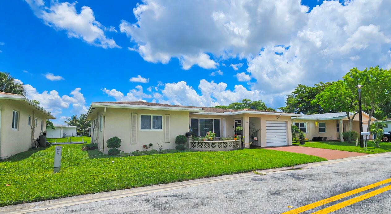 A single-story house with a tan exterior, a white garage door, and a front lawn — 7180 NW 10th Court, Margate FL 33063, MARGATE, FL