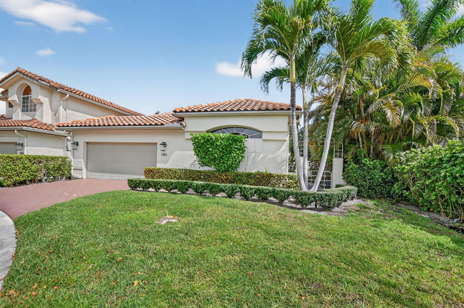 A single-story house with a beige stucco exterior, a tile roof, and a two-car garage — 5184 NW 25th Way, Boca Raton FL 33496, BOCA RATON, FL