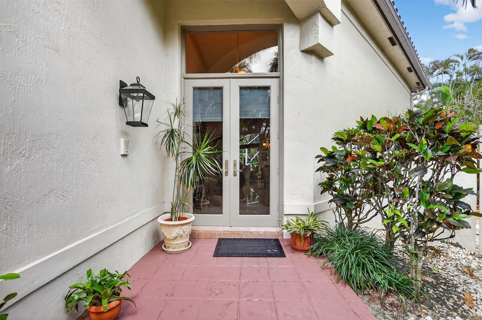A front entryway features double glass doors, a red tiled porch, and potted plants — 5184 NW 25th Way, Boca Raton FL 33496, BOCA RATON, FL