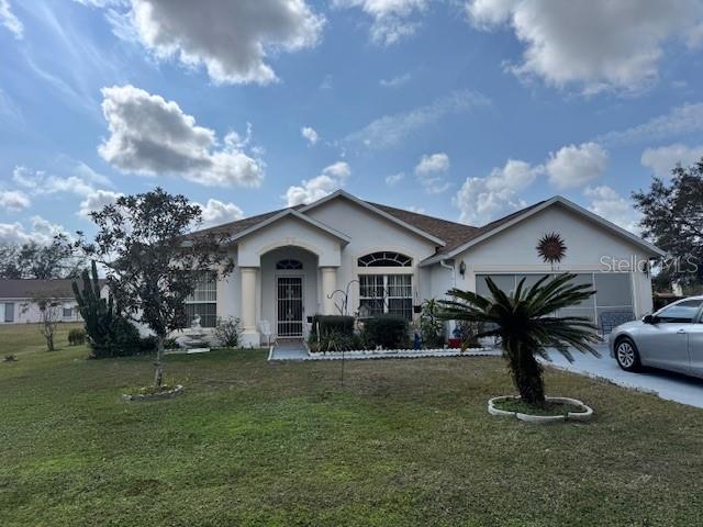 A single-story house with a light-colored exterior, a front porch, and a palm tree — 813 HALIFAX DRIVE, KISSIMMEE, FL