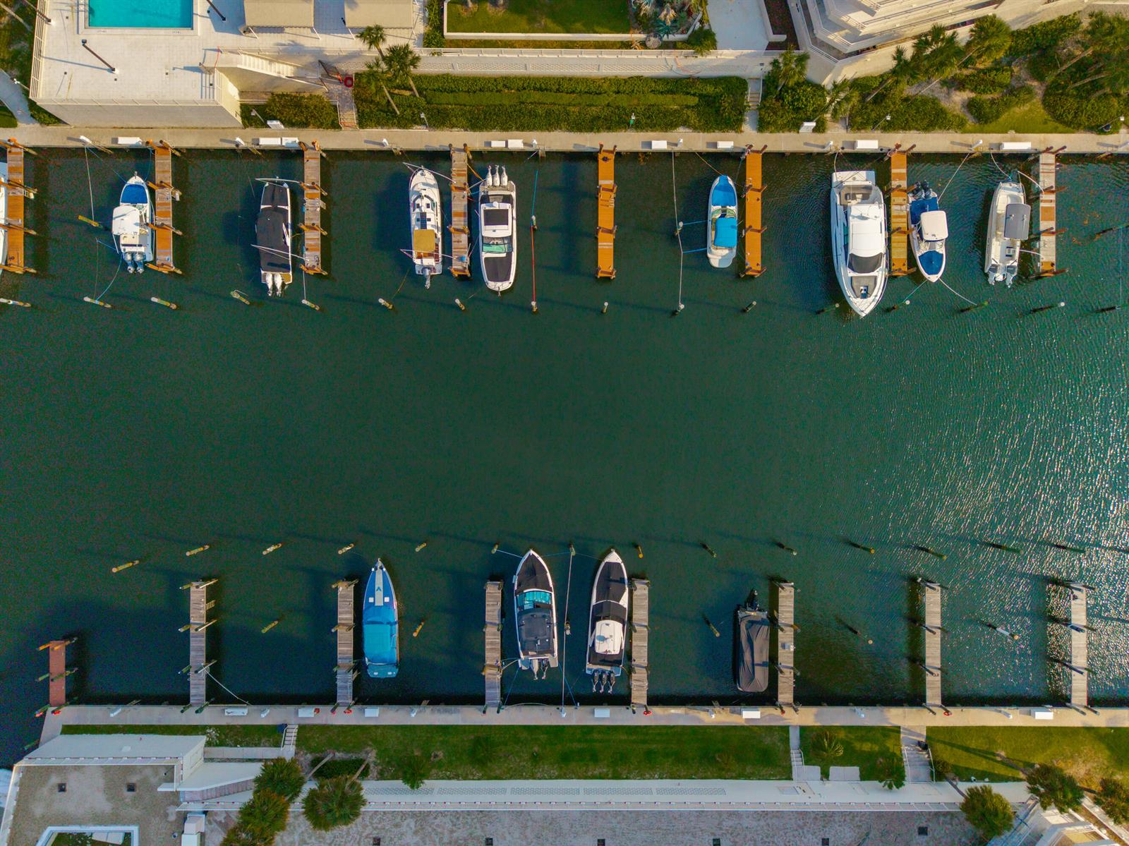 An aerial view shows boats docked at a marina along a narrow canal — 4201 N Ocean Boulevard # 508, Boca Raton FL 33431, BOCA RATON, FL