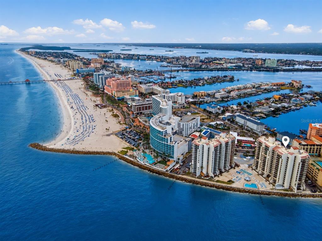 An aerial view of a coastal resort area with high-rise hotels along a sandy beach — 450 S GULFVIEW BOULEVARD UNIT 705, CLEARWATER BEACH, FL