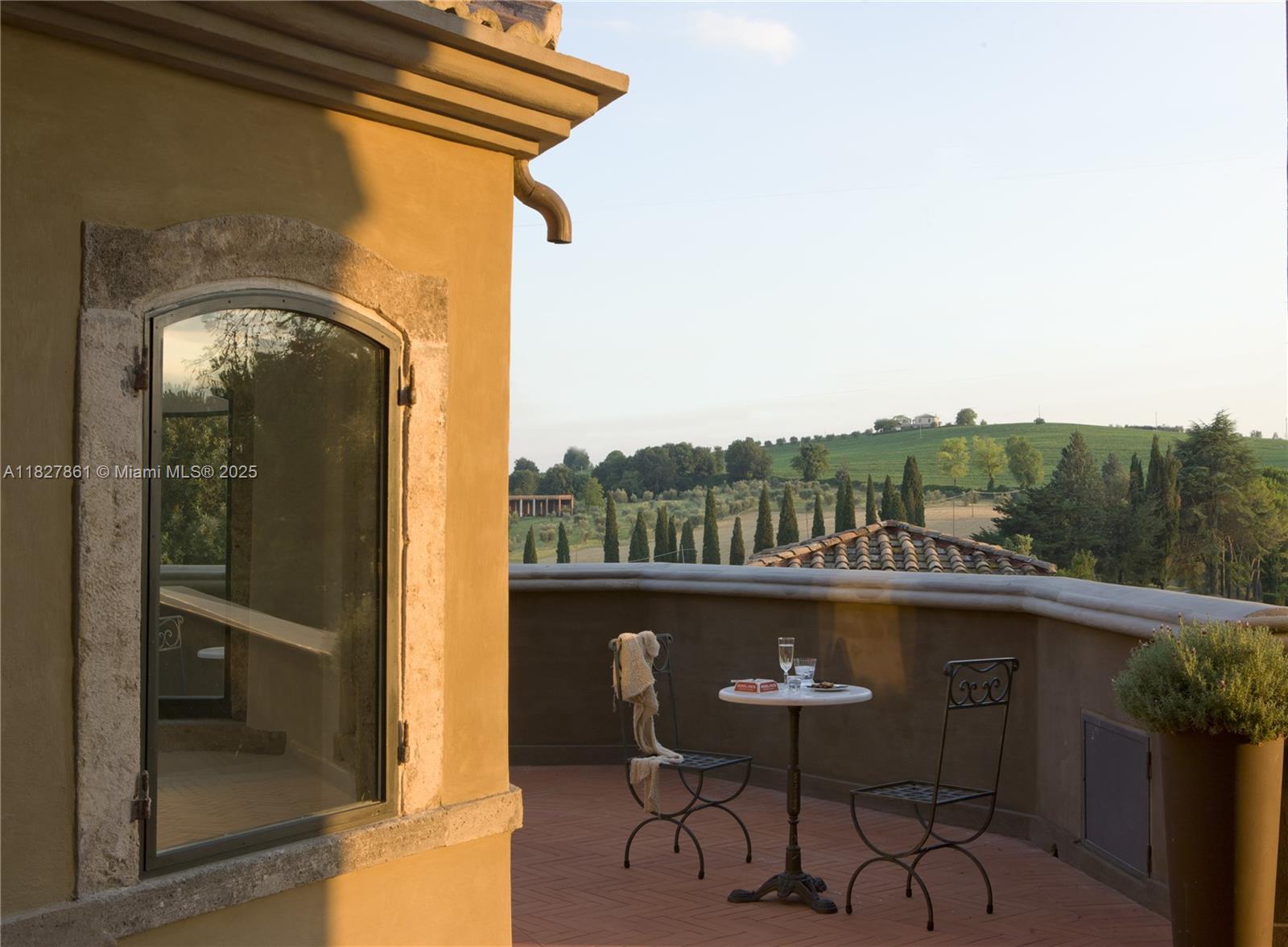 A terrace with a small table and two chairs overlooks a rolling landscape — HOTEL FOR SALE UMBRIA ITALY, 0, 0