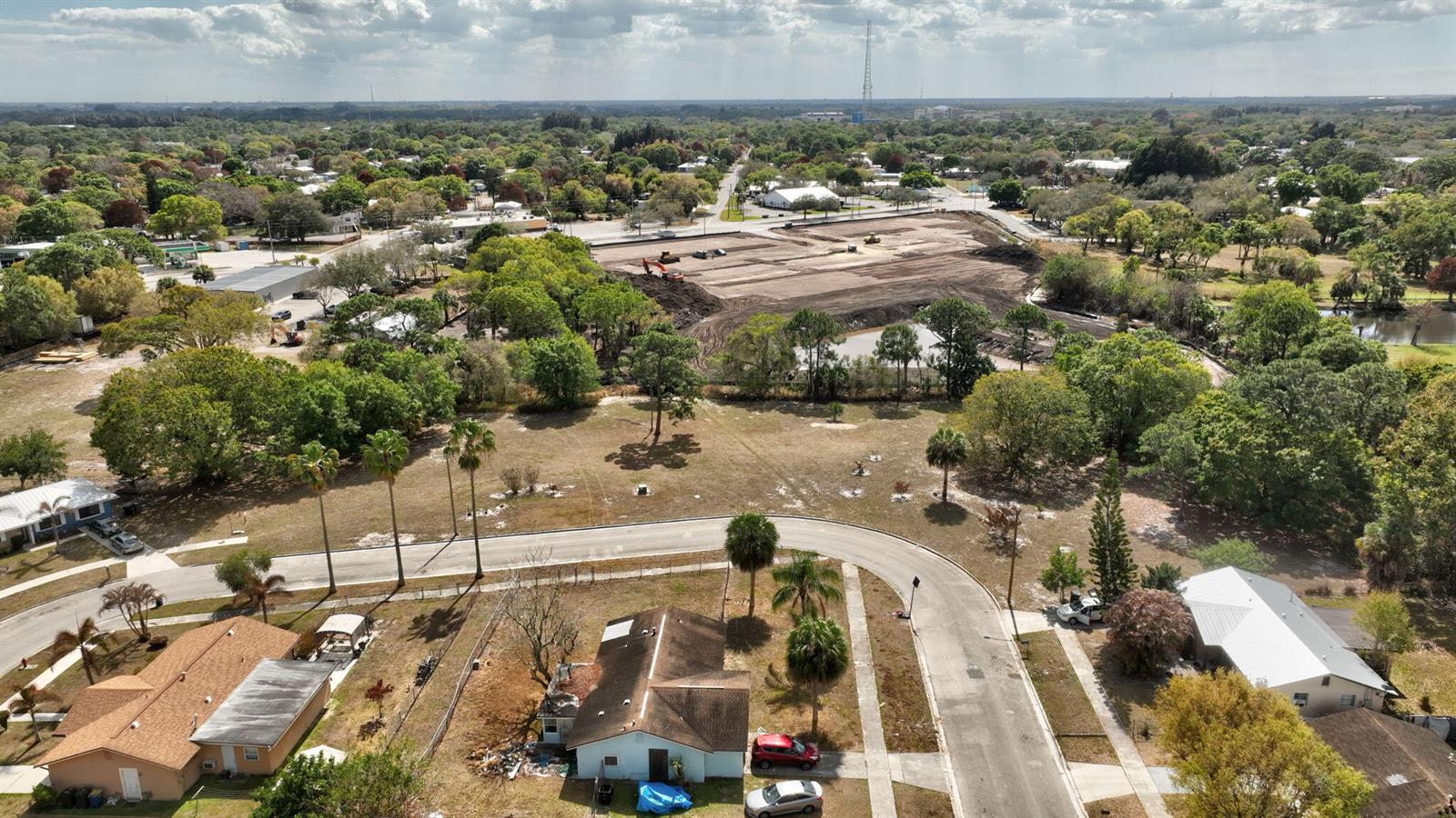 An aerial view shows a residential neighborhood with a large cleared construction site nearby — 0 Hemlock Circle, Fort Pierce FL 34947, FORT PIERCE, FL