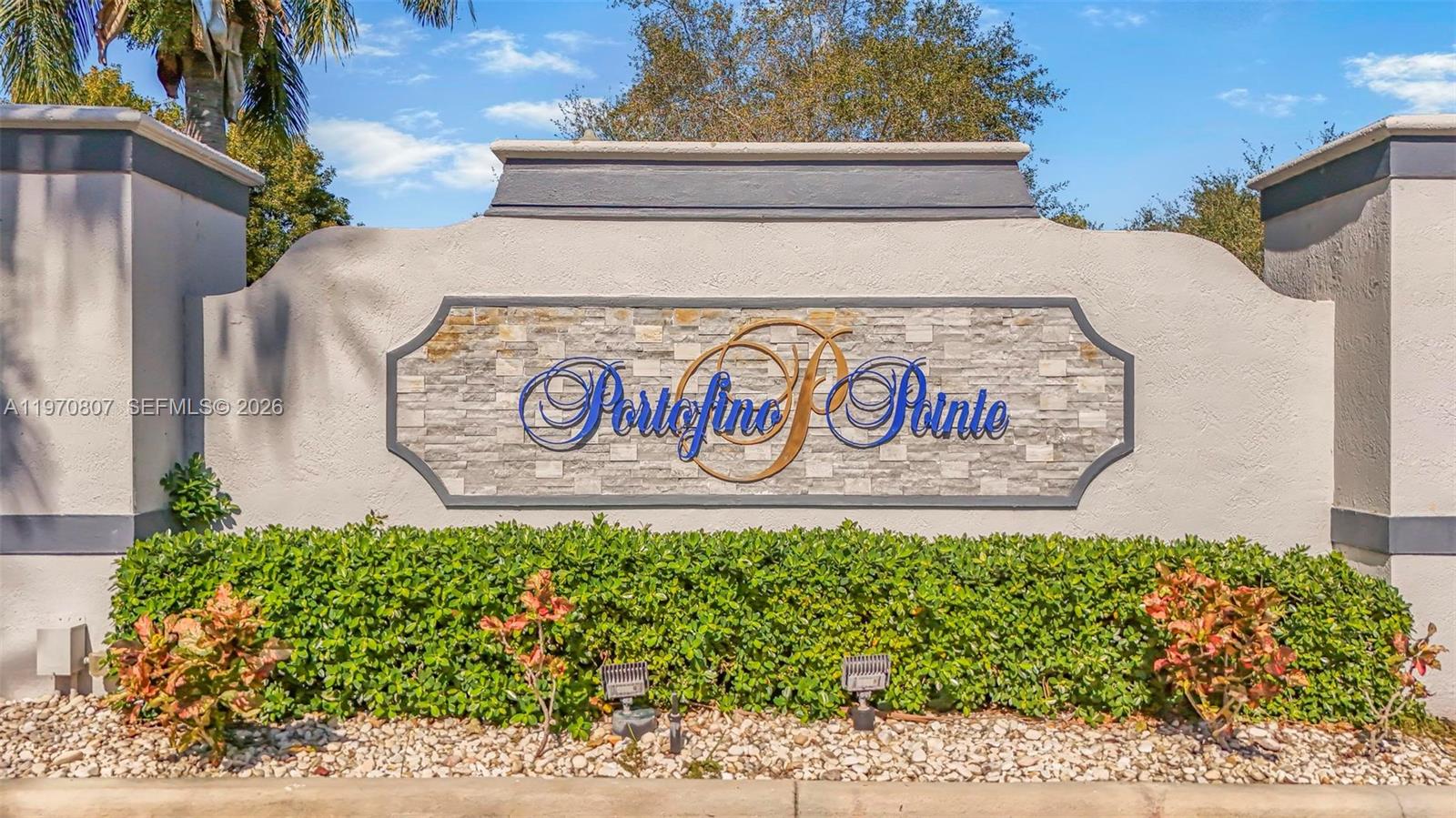 A stone-accented monument sign for Portofino Pointe stands behind a landscaped hedge — 3736 NE 9 CT, Homestead FL 33033, HOMESTEAD, FL