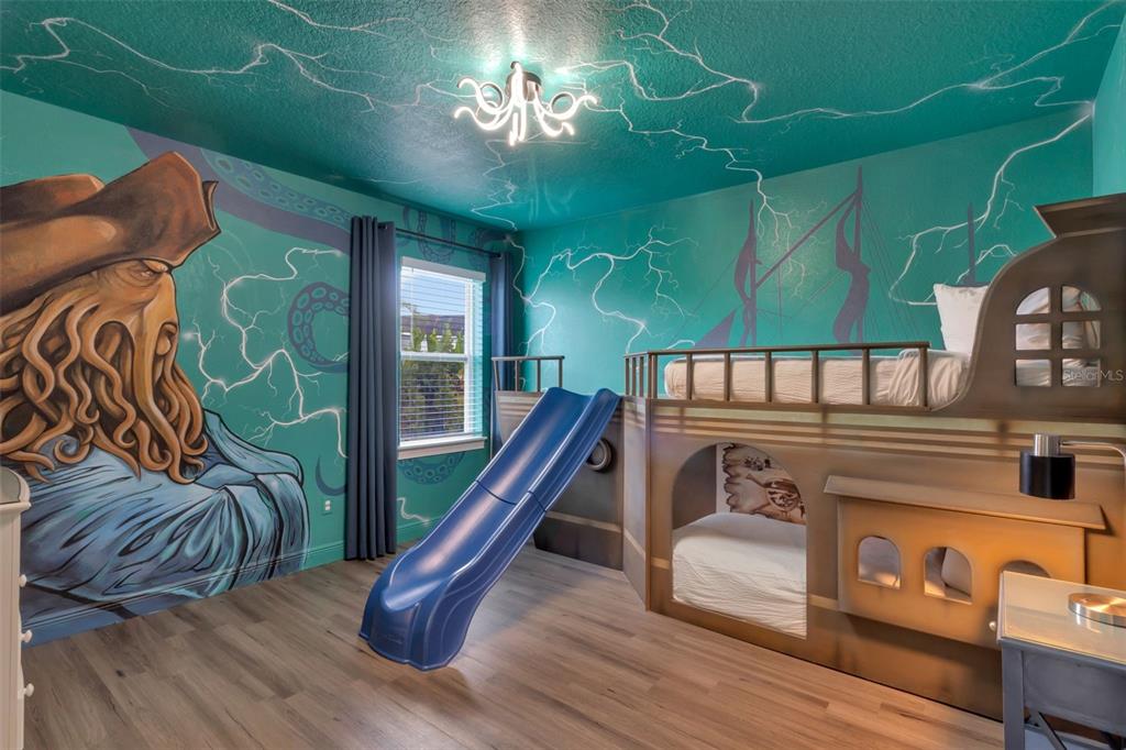 A themed bedroom features a pirate ship bunk bed with a slide and Davy Jones mural — 7643 WILMINGTON LOOP, KISSIMMEE, FL