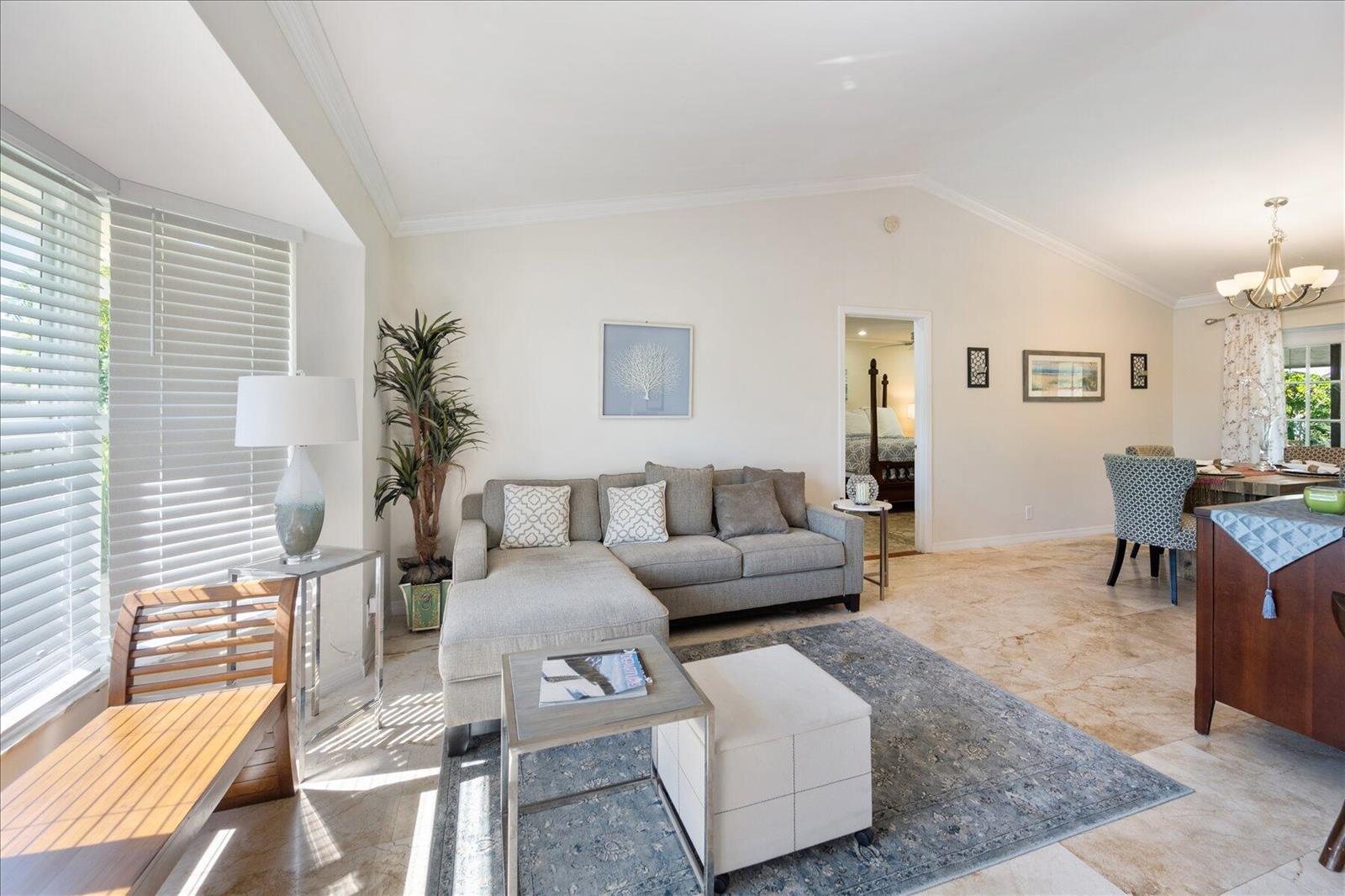 A living room with a gray sectional sofa, area rug, and tile flooring — 13889 Geranium Place, Wellington FL 33414, WELLINGTON, FL