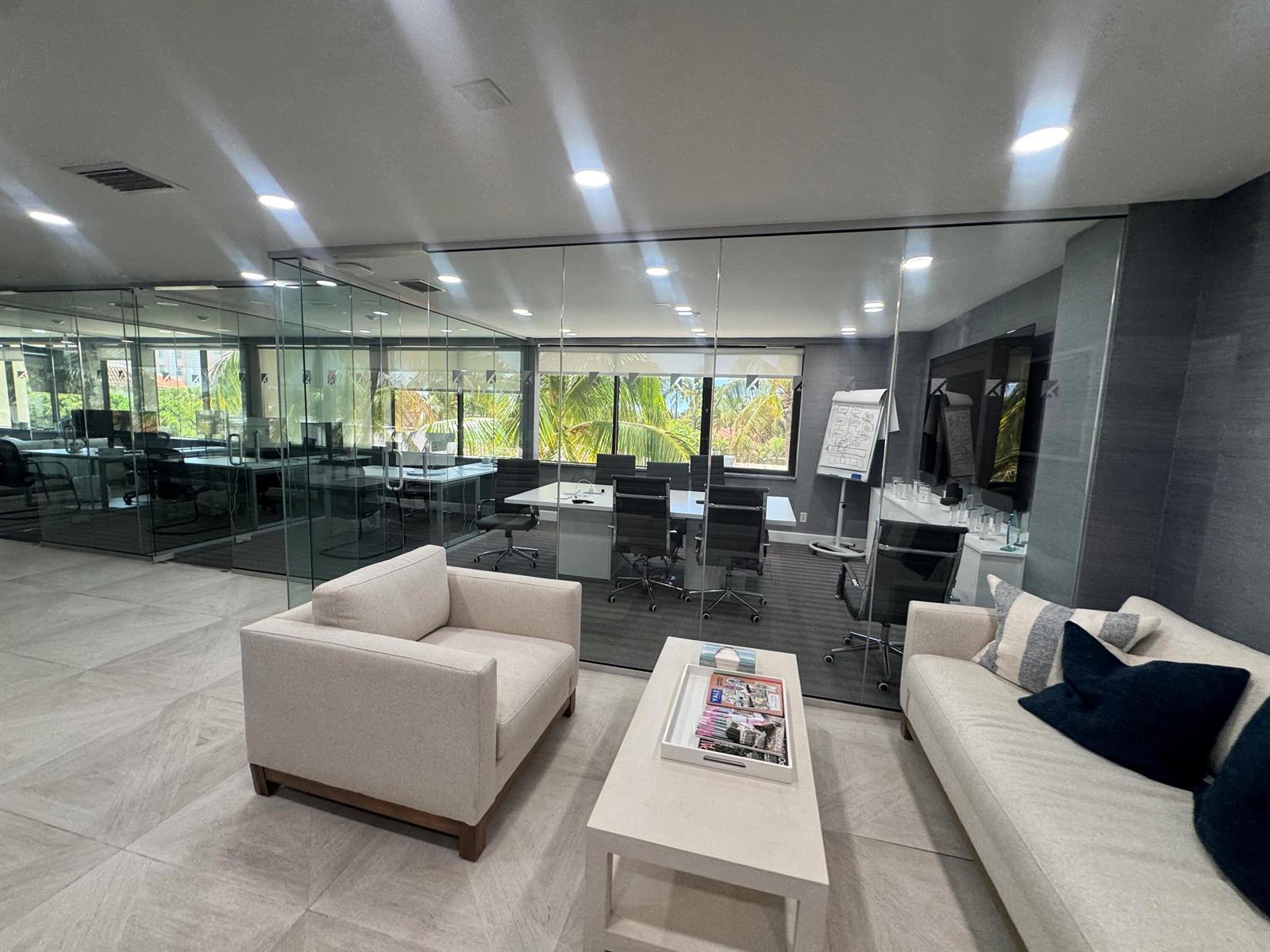 A modern office suite features a glass-enclosed conference room, a lounge area, and large windows — 201 Worth Avenue # 301, Palm Beach FL 33480, PALM BEACH, FL