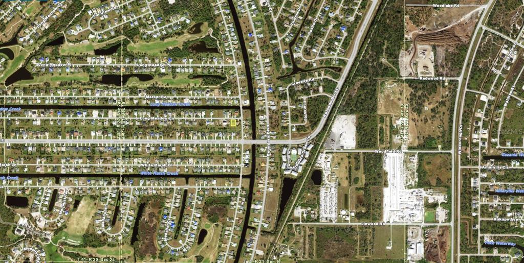 This is an aerial map view of a residential neighborhood with streets and waterways — 293 LONG MEADOW LANE, ROTONDA WEST, FL