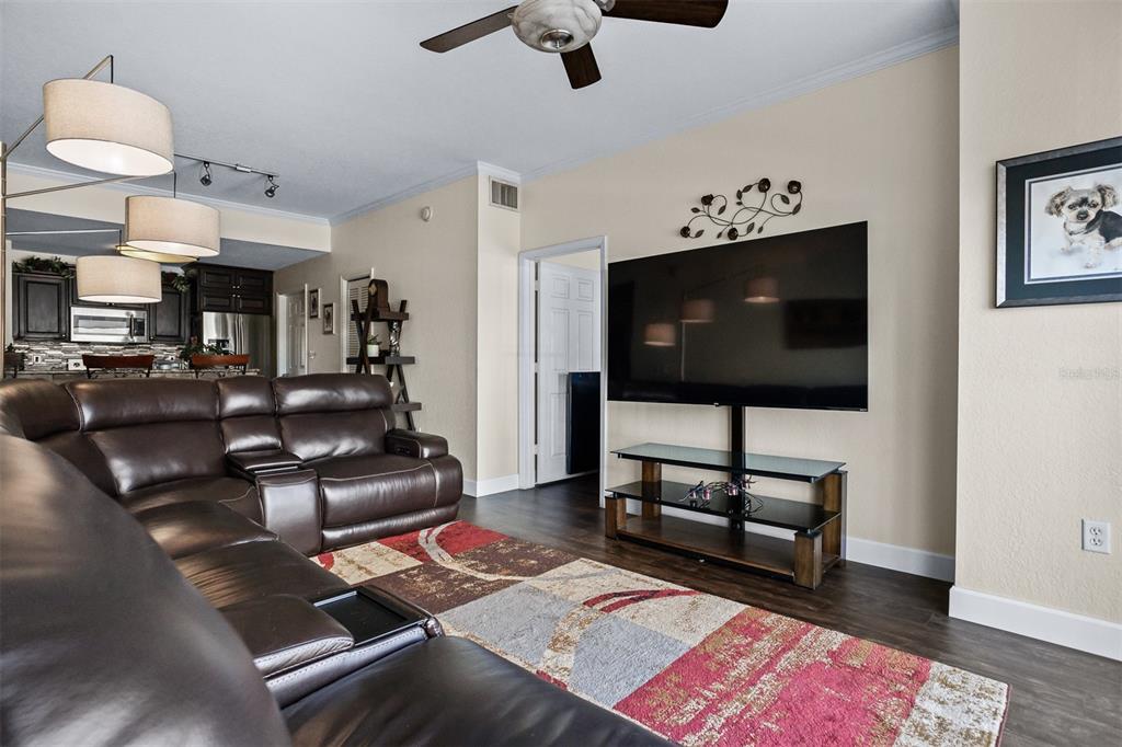 A living room features a brown leather sectional, a television on a stand, and flooring — 700 S HARBOUR ISLAND BOULEVARD UNIT 532, TAMPA, FL