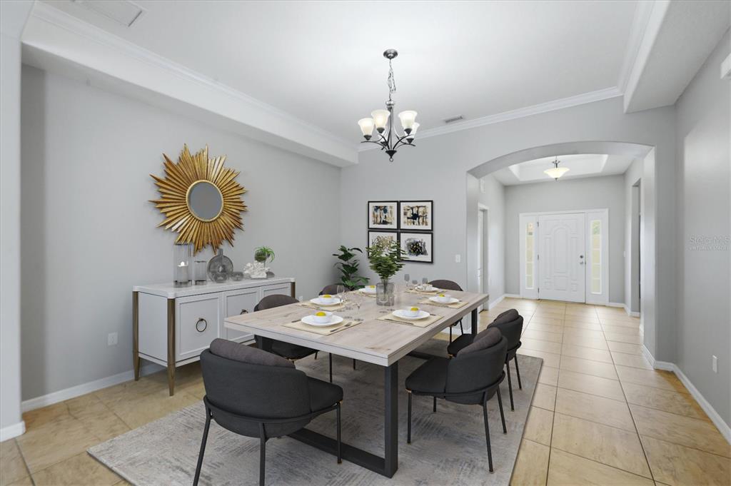 A dining room features a rectangular table with six chairs, a sideboard, and a sunburst mirror — 12218 LAVENDER LOOP, BRADENTON, FL
