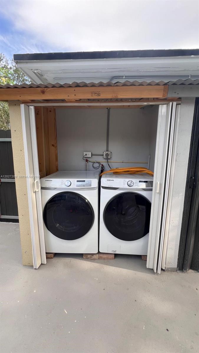 Two white Samsung laundry appliances sit in an outdoor utility closet with folding doors — 841 S 24th Ave # B, Hollywood FL 33020, HOLLYWOOD, FL
