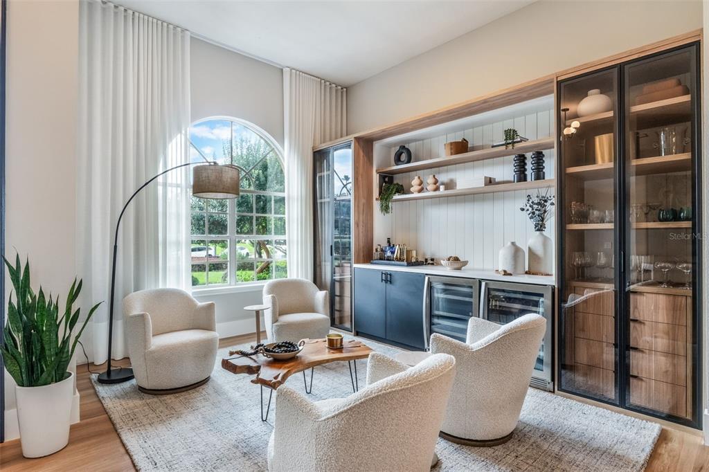 A living room features four cream armchairs, a live-edge coffee table, and a built-in bar — 12718 WINDERMERE ISLES PLACE, WINDERMERE, FL