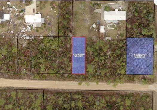 An aerial map view shows a highlighted rectangular plot of land bordering a dirt road — EVERGREEN STREET, FOUNTAIN, FL