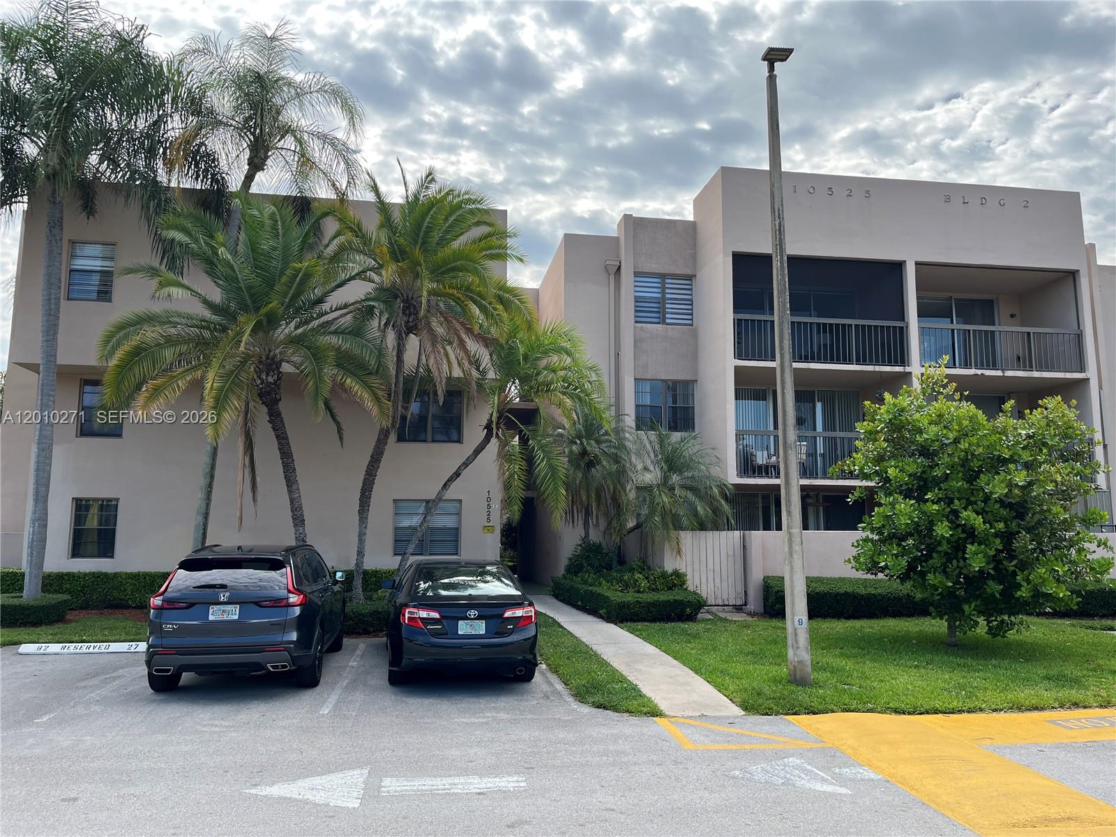 A three-story apartment building exterior features palm trees, a parking lot, and balconies — 10525 SW 112th Ave # 314, Miami FL 33176, MIAMI, FL