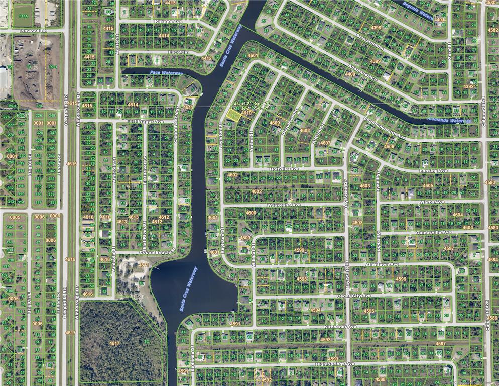 This is an aerial map showing a residential neighborhood with canals and numerous land parcels — 10008 BOYLSTON STREET, PORT CHARLOTTE, FL