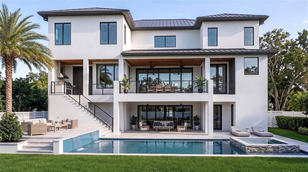 A modern multi-story house features a swimming pool, a patio, and a second-floor balcony — 577 W DAVIS BOULEVARD, TAMPA, FL