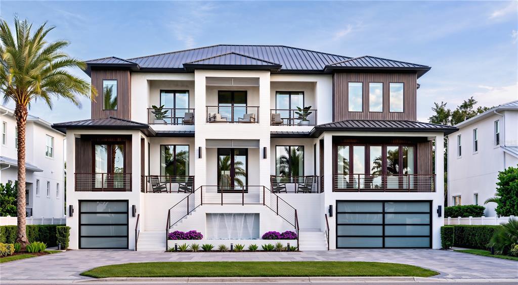 A three-story modern house with a metal roof, balconies, and two ground-level garage doors — 577 W DAVIS BOULEVARD, TAMPA, FL