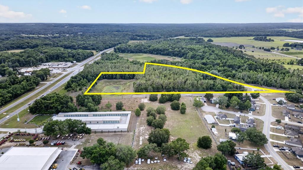 An aerial view shows a large, wooded plot of land outlined in yellow near roads — 0 MONDON HILL ROAD, BROOKSVILLE, FL