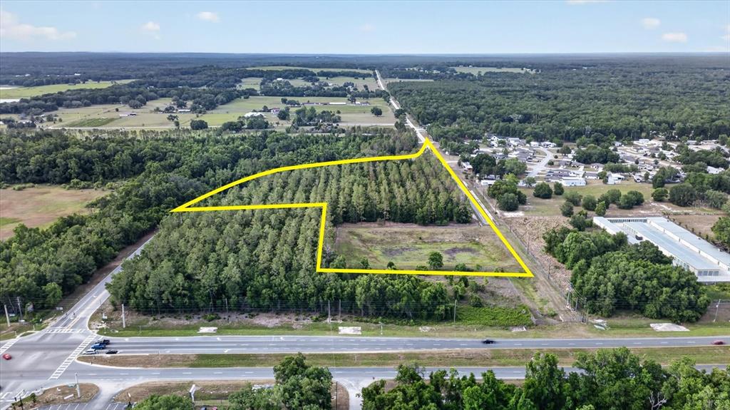 An aerial view shows a large, wooded plot of land outlined in yellow near a road — 0 MONDON HILL ROAD, BROOKSVILLE, FL