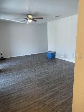 An empty room features gray wood-look flooring, white walls, and a ceiling fan — 7210 N MANHATTAN AVENUE UNIT 621, TAMPA, FL