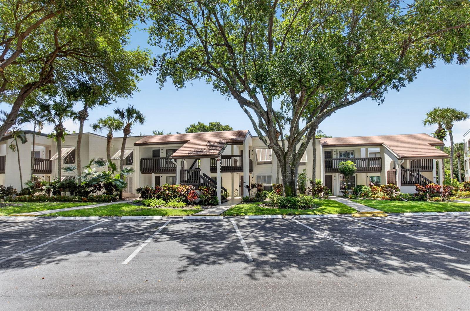A two-story apartment building with balconies and a parking lot in front — 10187 Mangrove Drive # 201, Boynton Beach FL 33437, BOYNTON BEACH, FL