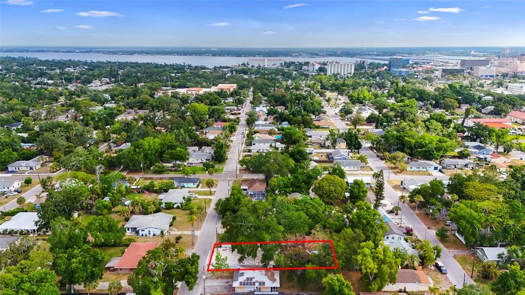 An aerial view shows a residential neighborhood with a vacant lot outlined in red — 1419 18TH STREET W UNIT W, BRADENTON, FL