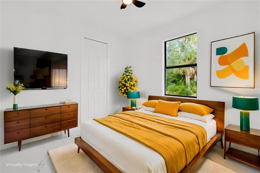 A virtually staged bedroom features a wooden bed with yellow bedding and a matching dresser — 1278 MILIKEN TERRACE, PORT CHARLOTTE, FL