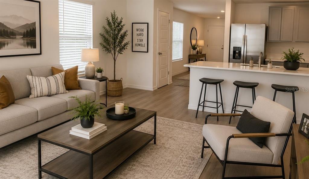 A living room with a sofa, coffee table, and armchair opens to a kitchen with stools — 230 BULL FROG LANE, UMATILLA, FL