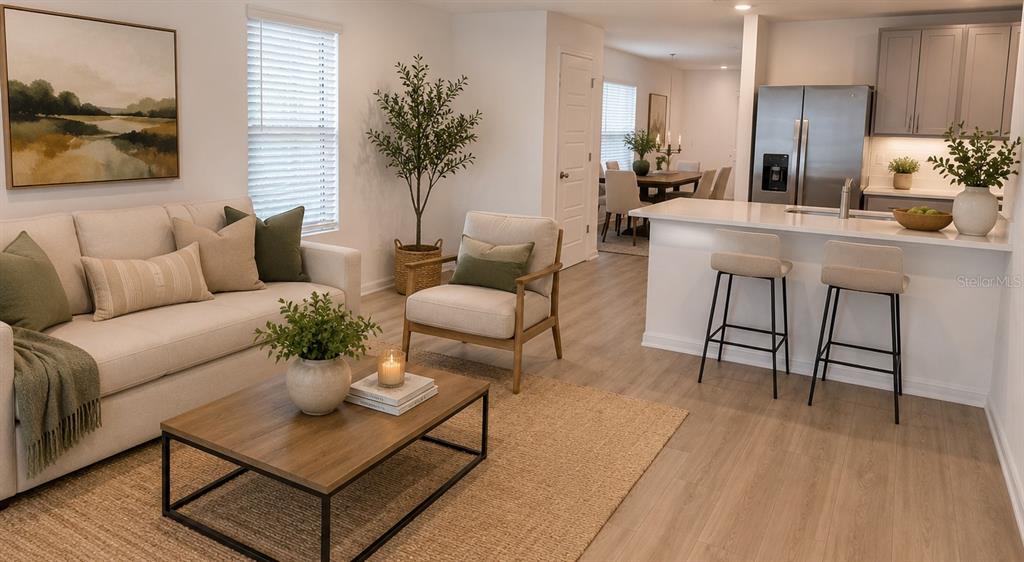 A living room with a sofa, coffee table, and armchair opens to a kitchen with barstools — 230 BULL FROG LANE, UMATILLA, FL
