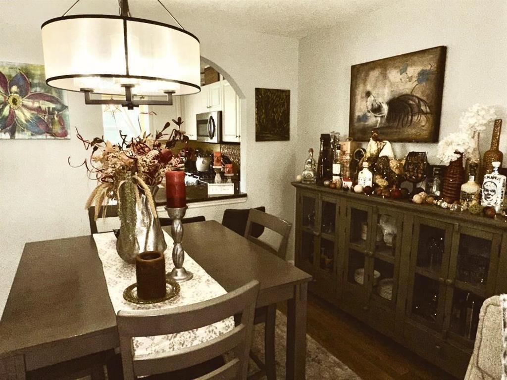 A dining room features a dark wood table, a matching sideboard, and a drum pendant light — 891 N REMBRANDT WAY, INVERNESS, FL