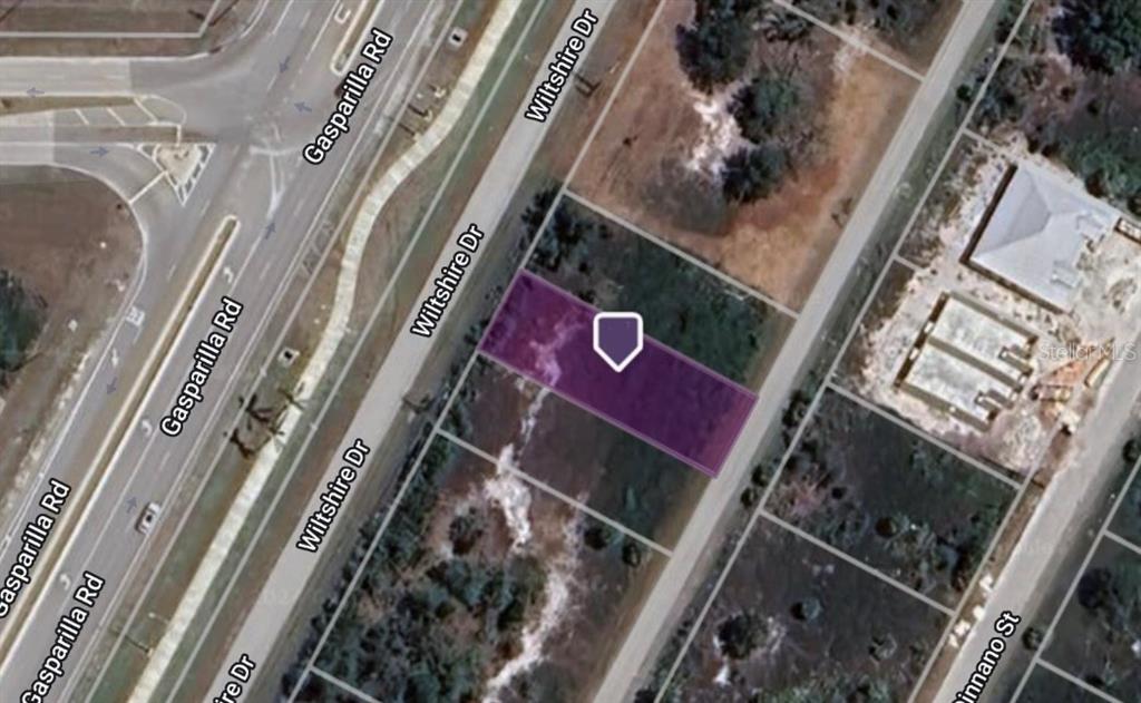This is an aerial map view of a vacant residential lot highlighted in purple — 8600 & 8606 WILTSHIRE DRIVE, PORT CHARLOTTE, FL