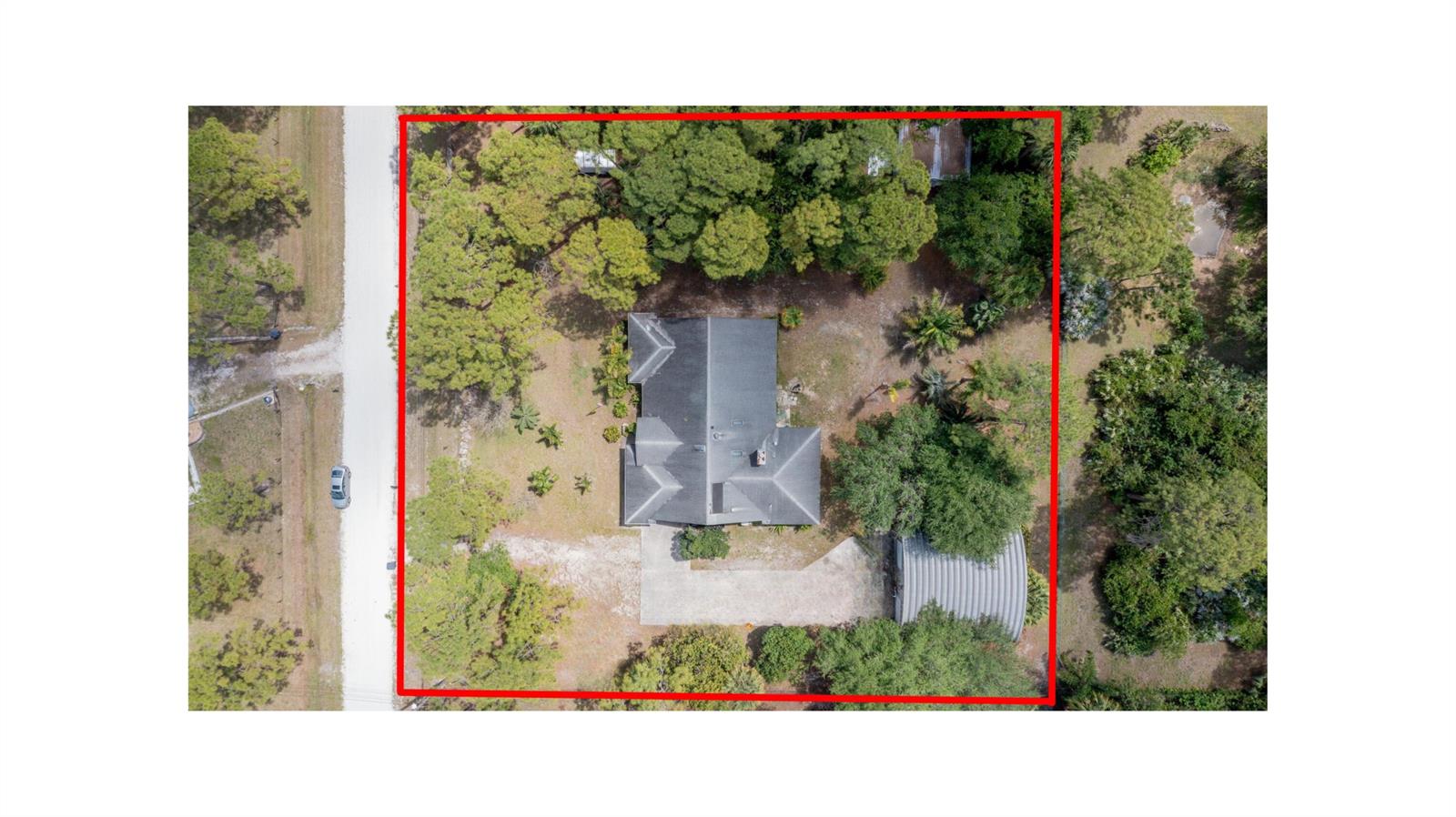 An aerial view shows a house with a metal outbuilding on a wooded lot — 15578 89th Place N, Loxahatchee FL 33470, LOXAHATCHEE, FL