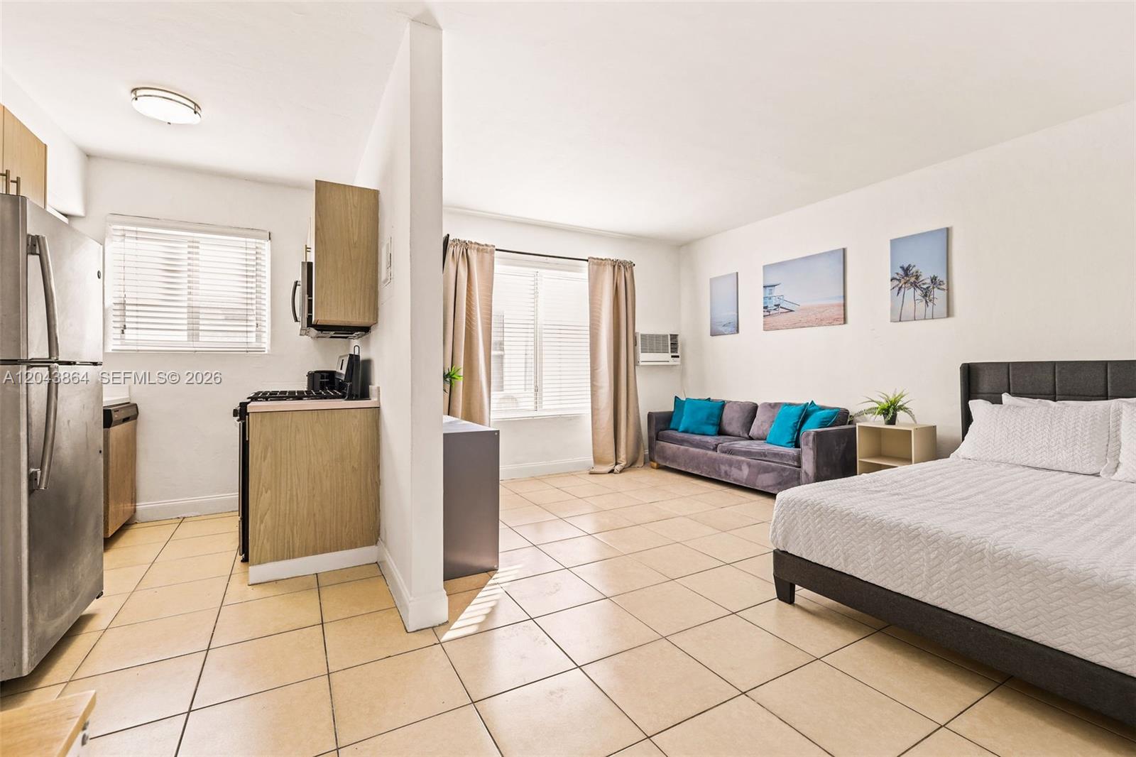This studio apartment features a kitchen, living area, and bedroom with light-colored tile floors — 7340 Harding Ave # 16, Miami Beach FL 33141, MIAMI BEACH, FL