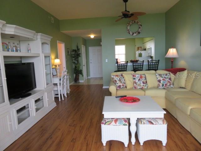 A living room features a white entertainment center, yellow sofa, and a white coffee table — 2625 TERRA CEIA BAY BOULEVARD UNIT 802, PALMETTO, FL