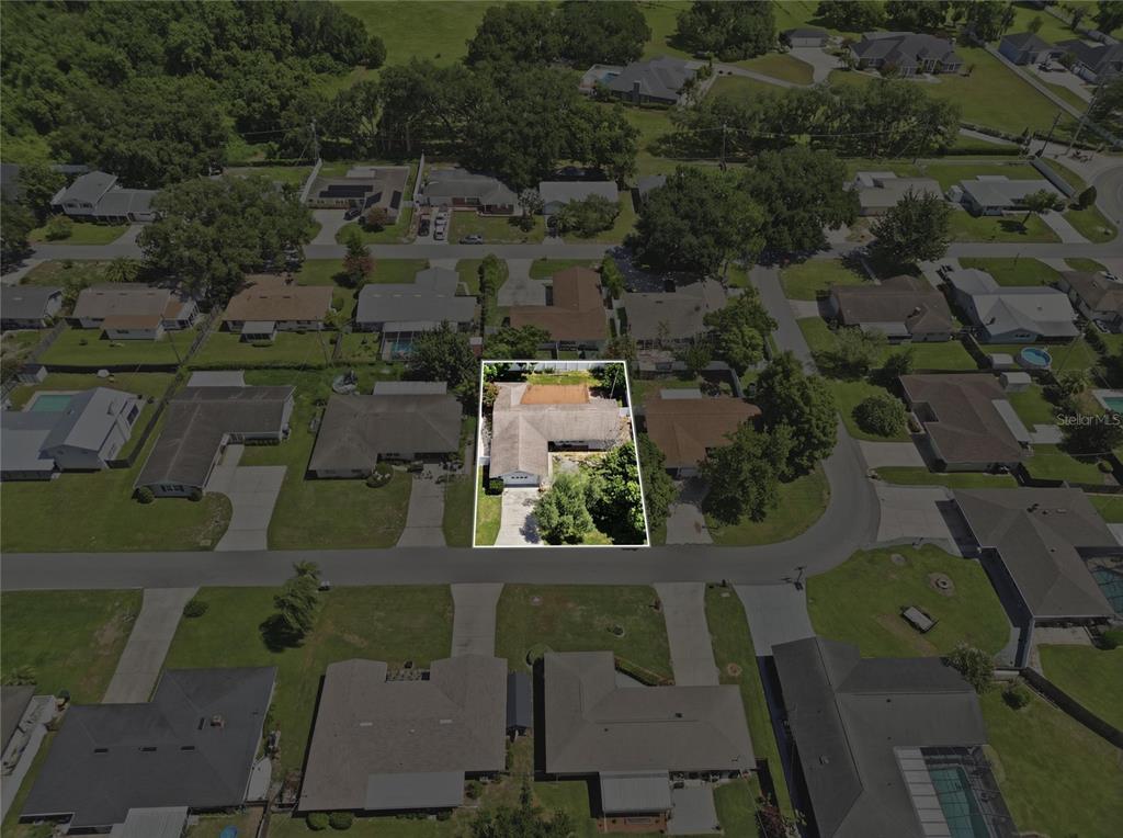 An aerial view shows a single-story residential house highlighted within a white border — 118 BROWNING CIRCLE, WINTER HAVEN, FL