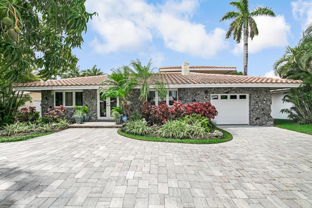 A single-story house with a stone facade, tile roof, and a paved driveway — 491 SE 16th Avenue, Pompano Beach FL 33060, POMPANO BEACH, FL