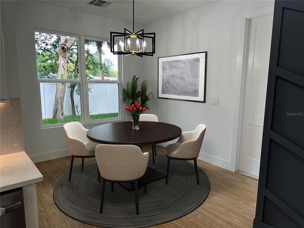 A dining area features a round dark wood table, four chairs, and a modern chandelier — 1317 E HARDING STREET, ORLANDO, FL