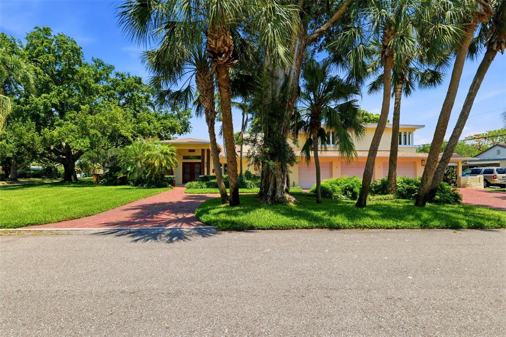 A two-story house with a brick driveway, palm trees, and a three-car garage — 6000 2ND STREET S, ST PETERSBURG, FL
