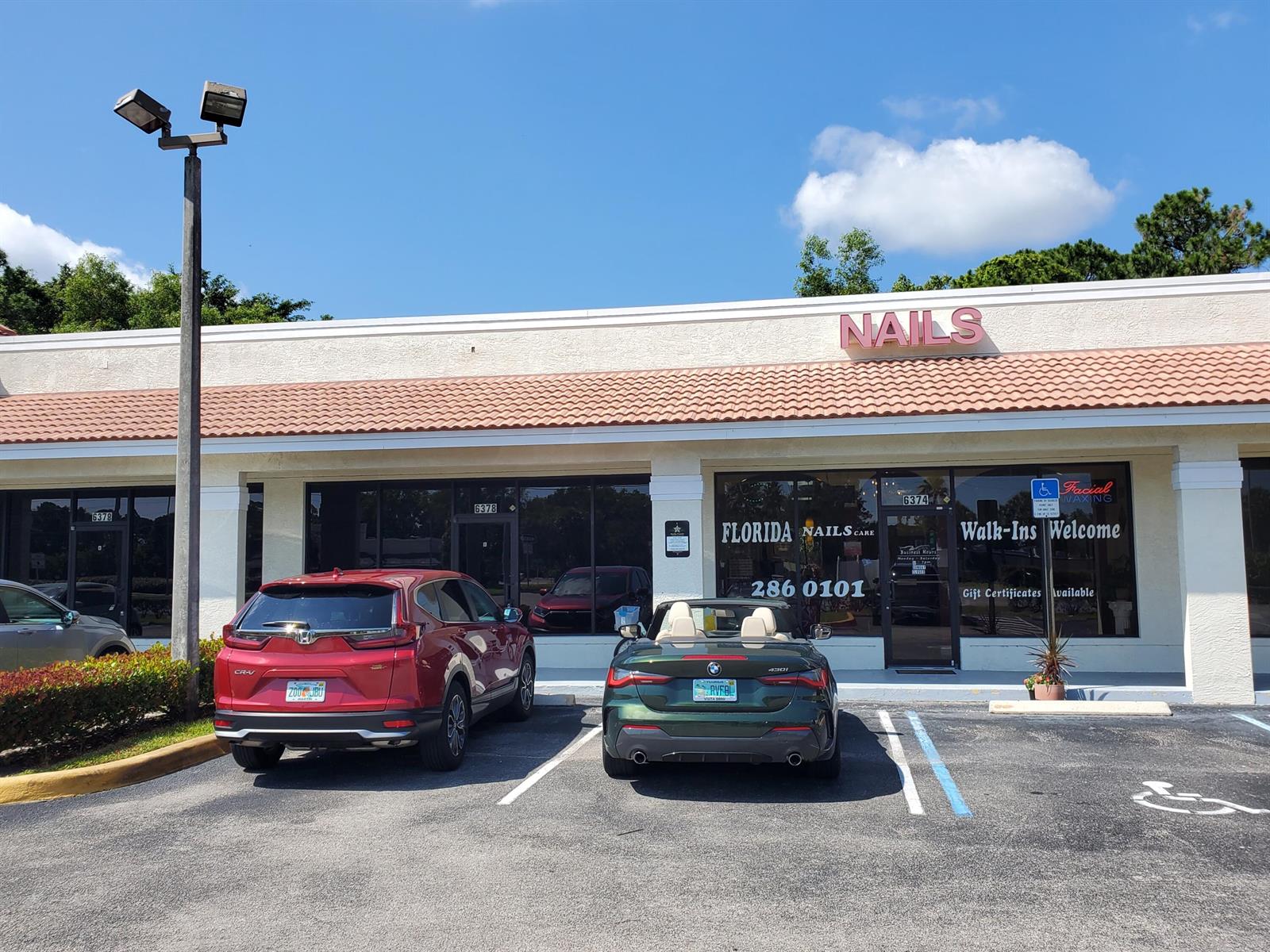 A red SUV and a green convertible are parked in front of a nail salon — 6374 SE Federal Highway # 6374, Stuart FL 34997, STUART, FL
