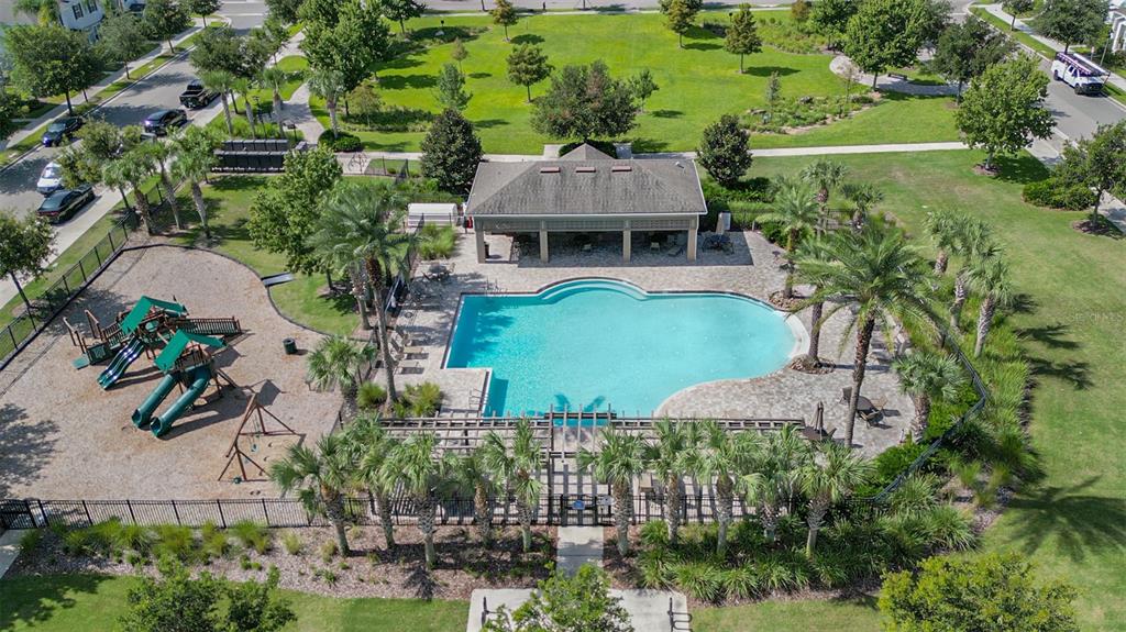 An aerial view of a community swimming pool, a playground, and a covered pavilion — 6208 ARALIA IVY LANE, WINTER GARDEN, FL