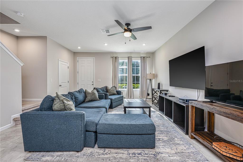 An aerial view shows a two-story townhouse with a corner lot and surrounding landscaping — 6208 ARALIA IVY LANE, WINTER GARDEN, FL