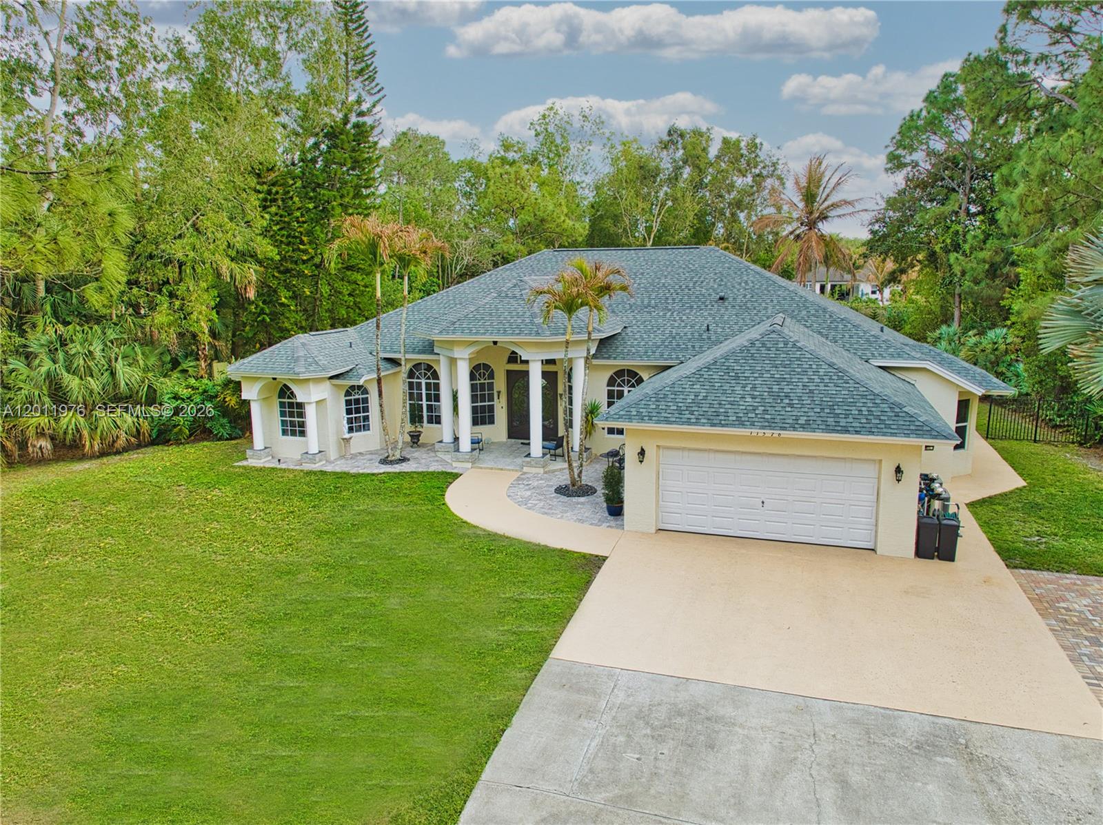 An aerial view shows a single-story house with a shingled roof and a two-car garage — 11576 N 153rd Ct N, Jupiter FL 33478, JUPITER, FL