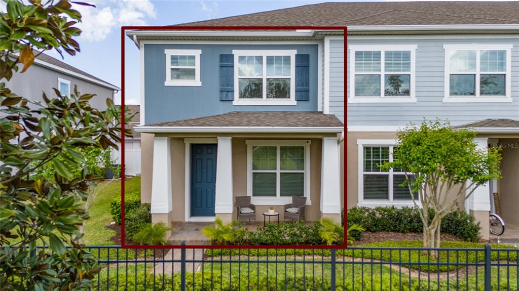The exterior of a two-story townhouse features a covered front porch and blue siding — 11162 HANLON TERRACE ALLEY, WINTER GARDEN, FL