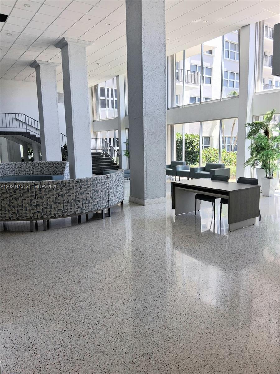 A spacious, modern lobby features high ceilings, large windows, polished floors, and contemporary seating areas — 405 N Ocean Blvd # 1815, Pompano Beach FL 33062, POMPANO BEACH, FL