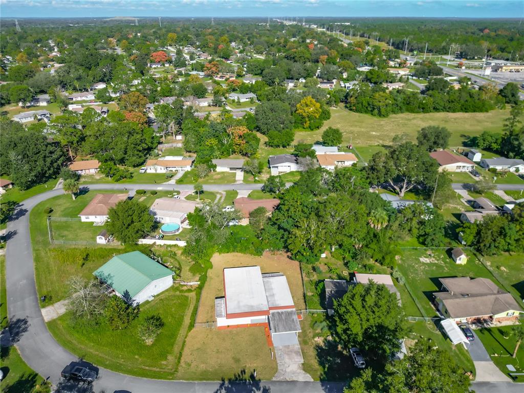 An aerial view shows a residential neighborhood with houses, green lawns, and mature trees — 46 LAKE COURT LOOP, OCALA, FL