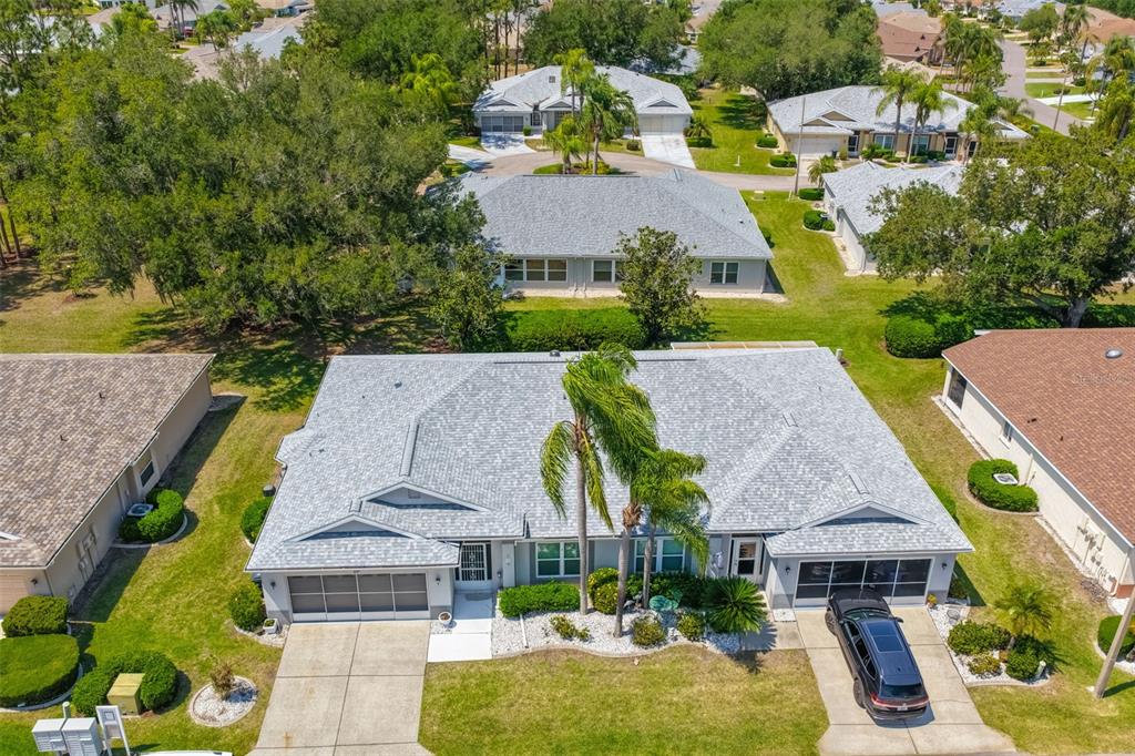 An aerial view of a suburban house with a gray roof and a two-car garage — 827 MCCALLISTER AVENUE UNIT 55, SUN CITY CENTER, FL