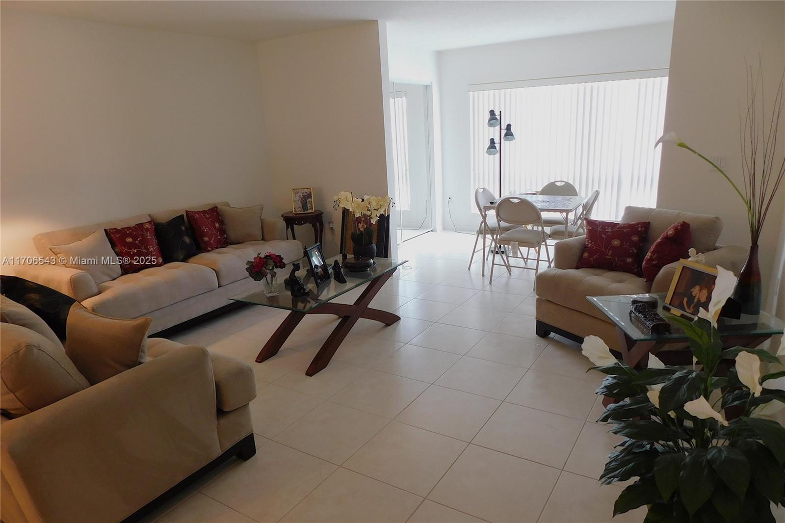 A living room with beige sofas, a glass coffee table, and a dining area nearby — 5749 Gemstone Ct # 307, Boynton Beach FL 33437, BOYNTON BEACH, FL