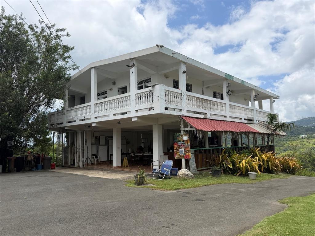 A two-story white building with a balcony and an open-air ground level patio — PR-172 KM 7.5 HACIENDA EL REMANSO, CAÑABONCITO WARD, CAGUAS, PR