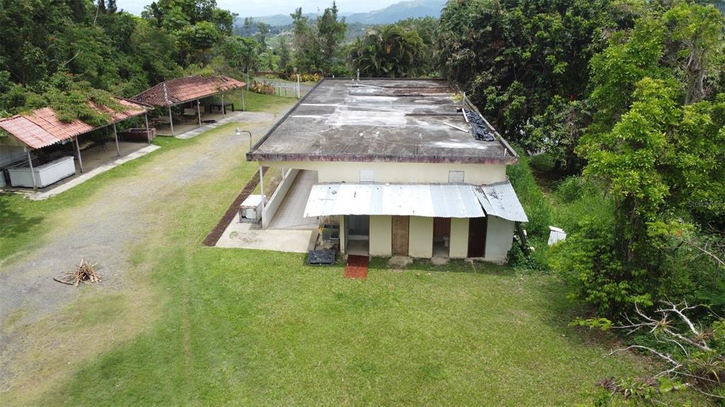 An aerial view shows a flat-roofed building with an attached metal awning and adjacent gazebo — PR-172 KM 7.5 HACIENDA EL REMANSO, CAÑABONCITO WARD, CAGUAS, PR